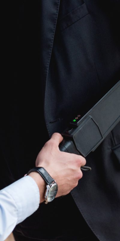 cropped-view-of-guard-using-metal-detector-2022-12-16-20-24-38-utc-1